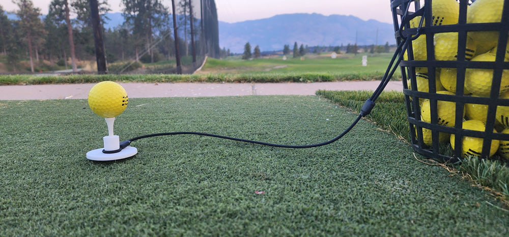 Tee Leash TL-O1 Original — product image — demo setup with rubber tee, durable elastic cord extended, and s-clip attached to range basket