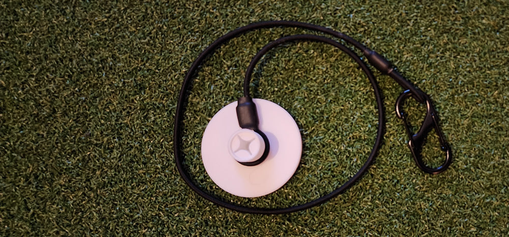 Tee Leash TL-O1 Original — product image — close-up of rubber tee with durable elastic cord and s-clip on turf